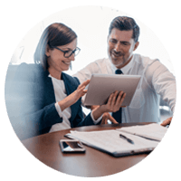 Business man and woman in meeting smiling over tablet device