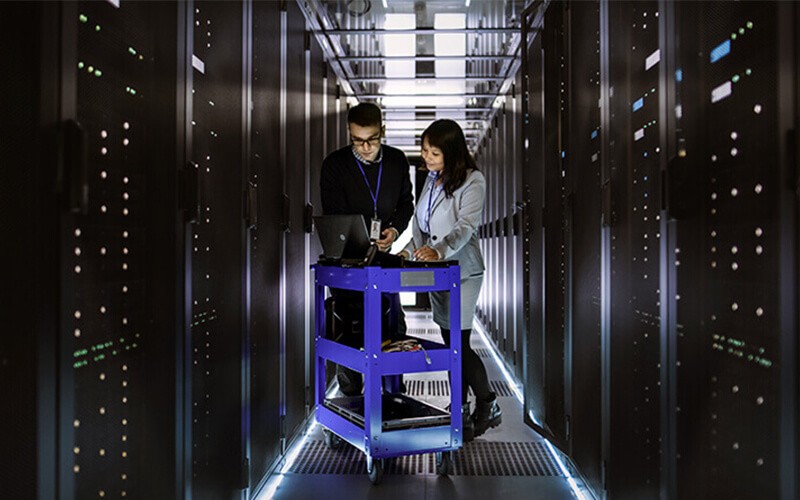 IT technicians review server information in data center